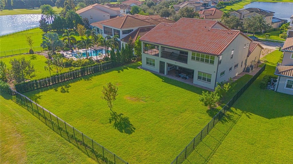 An aerial view of a two-story house with a fenced backyard and a swimming pool — 10846 MOBBERLEY CIRCLE, ORLANDO, FL