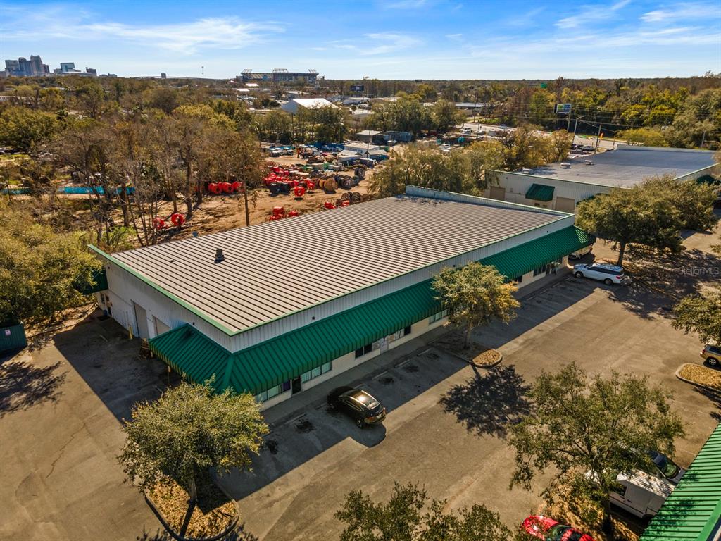 An aerial view shows a commercial building with a green metal roof and parking lot — 3239 OLD WINTER GARDEN ROAD UNIT 13, ORLANDO, FL