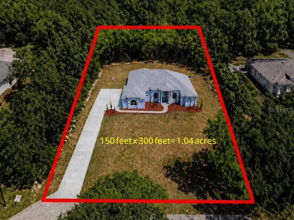 An aerial view shows a single-story house on a rectangular lot outlined in red — 421 W CHASE STREET, HERNANDO, FL