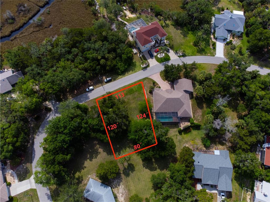 An aerial view shows a vacant residential lot outlined in red within a suburban neighborhood — 4648 S GATOR LOOP, HOMOSASSA, FL
