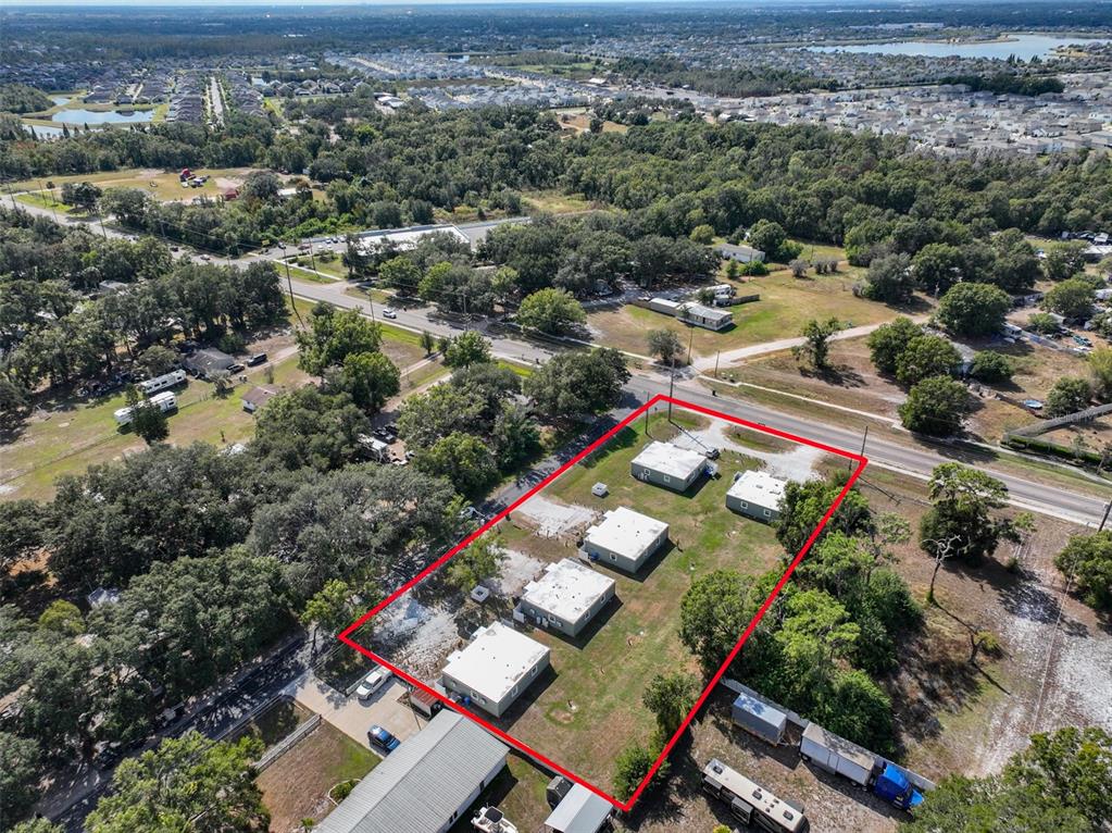 An aerial view shows a rectangular lot containing several small, flat-roofed buildings outlined in red — 11708 BALM RIVERVIEW ROAD, RIVERVIEW, FL
