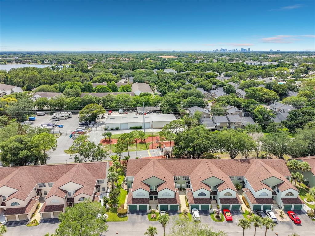An aerial view shows a row of townhouses with brown roofs and a parking lot — 3022 COTTAGE GROVE COURT UNIT 1807, ORLANDO, FL