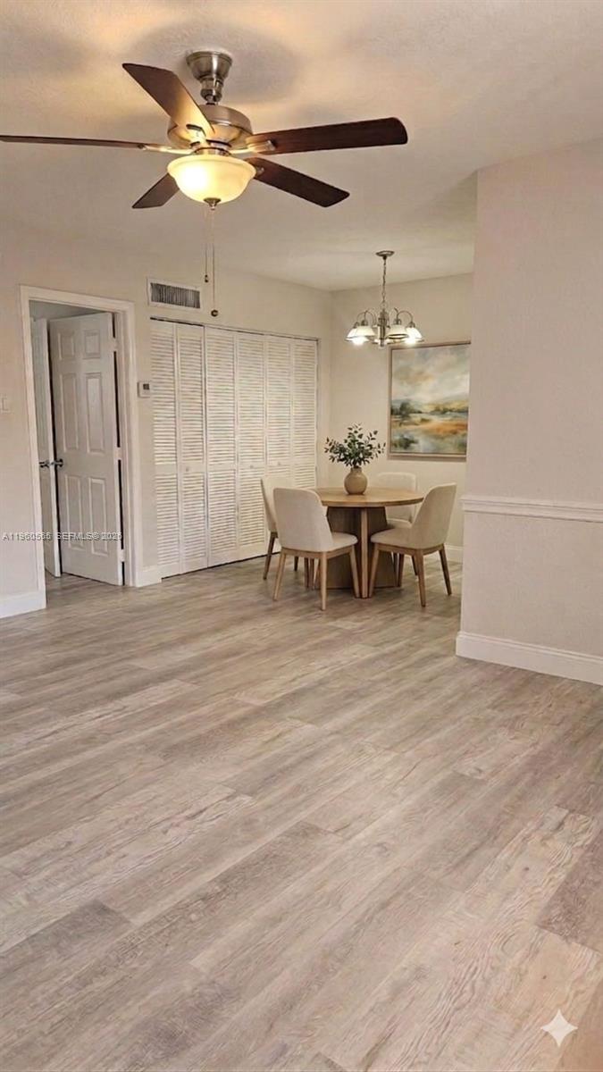 A dining area features a round table, four chairs, a ceiling fan, and light-colored flooring — 3800 SW 102nd Ave # 221, Miami FL 33165, MIAMI, FL