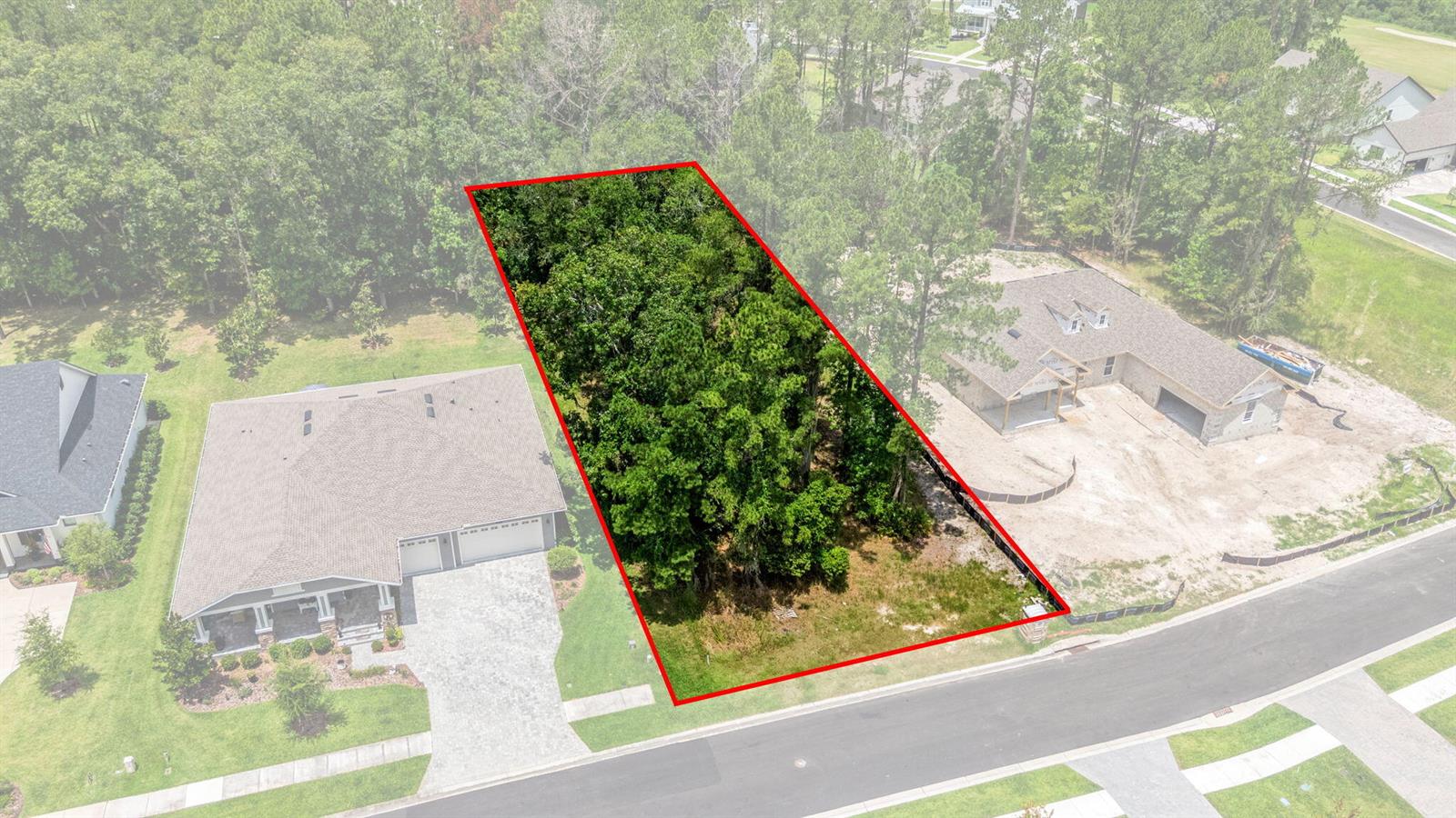 An aerial view shows a vacant, wooded residential lot outlined in red between two houses — 5049 Elm Leaf Drive, FL 34601, FL