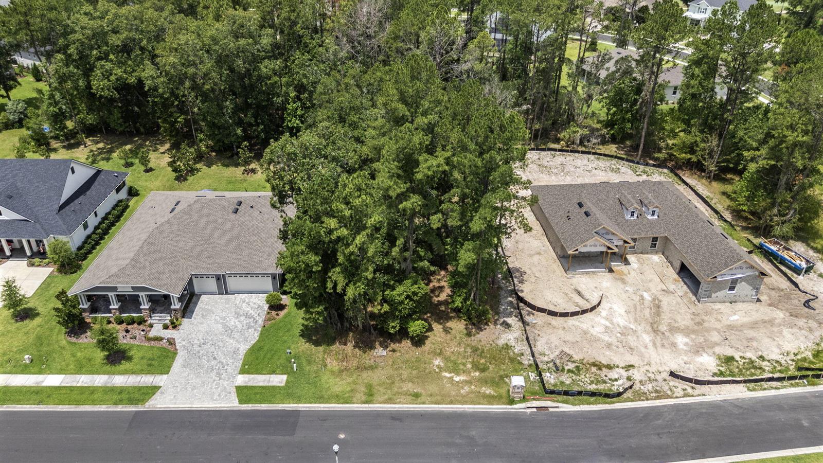 An aerial view shows a finished house and a neighboring home under construction — 5049 Elm Leaf Drive, FL 34601, FL