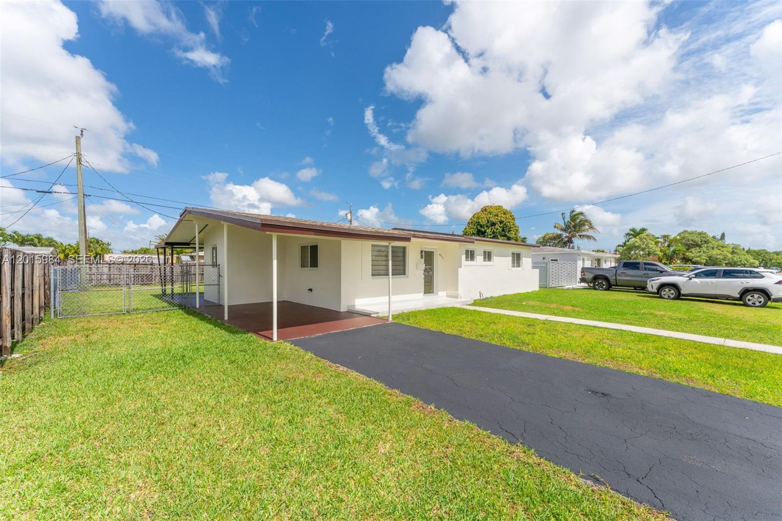 A single-story house features a carport, a paved driveway, and a grassy front yard — 4211 SW 97th Pl, Miami FL 33165, MIAMI, FL