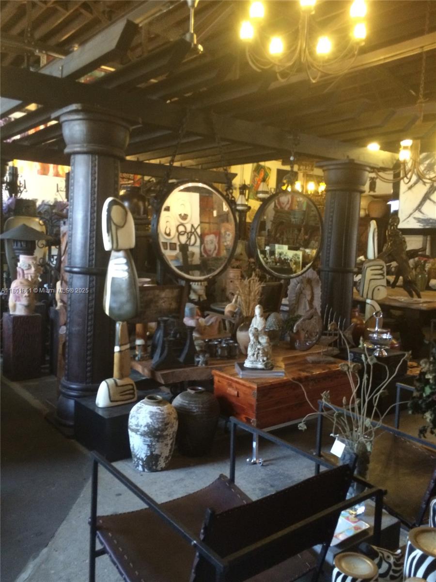 An interior view of a shop featuring large dark columns, circular mirrors, and various decorative sculptures — 101 NE 1st St, Dania Beach FL 33004, DANIA BEACH, FL
