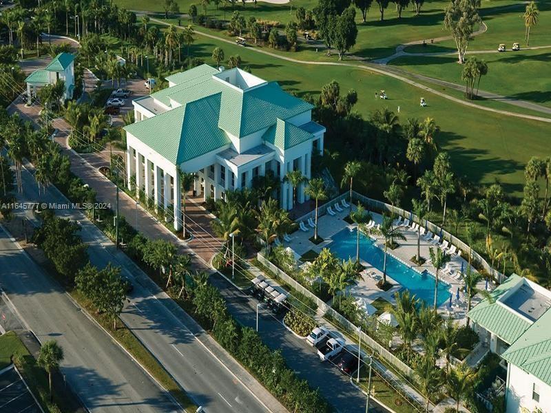 An aerial view shows a large clubhouse with a green roof, pool, and golf course — 5300 NW 87th Ave # 1308, Doral FL 33178, DORAL, FL