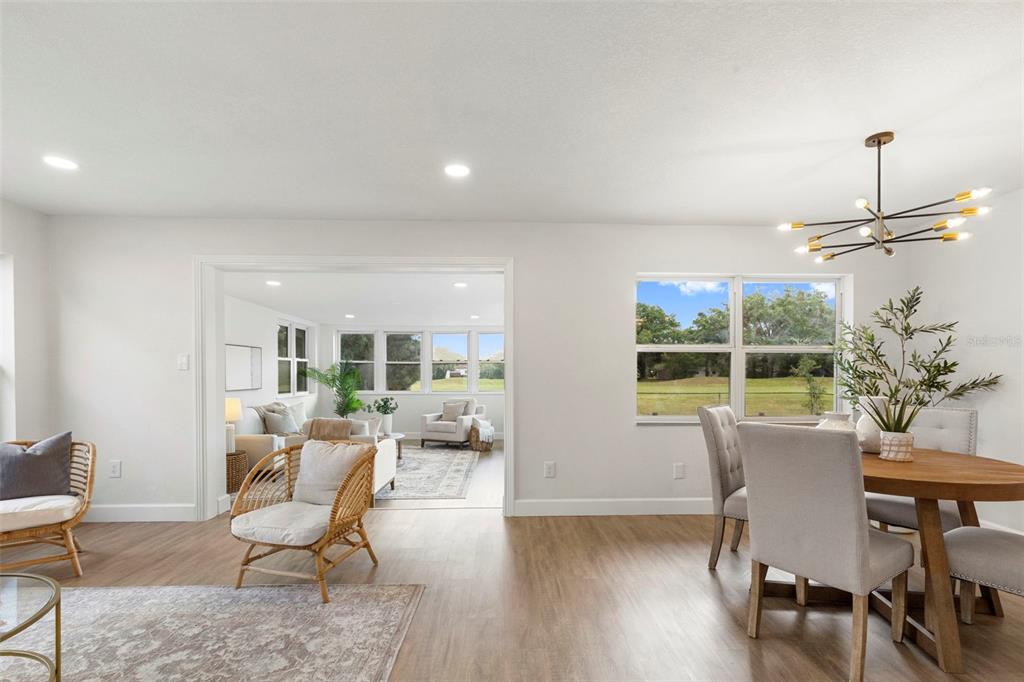 An aerial view shows a single-story house with two driveways, large trees, and a grassy yard — 10221 N FLEETWOOD DRIVE, TAMPA, FL