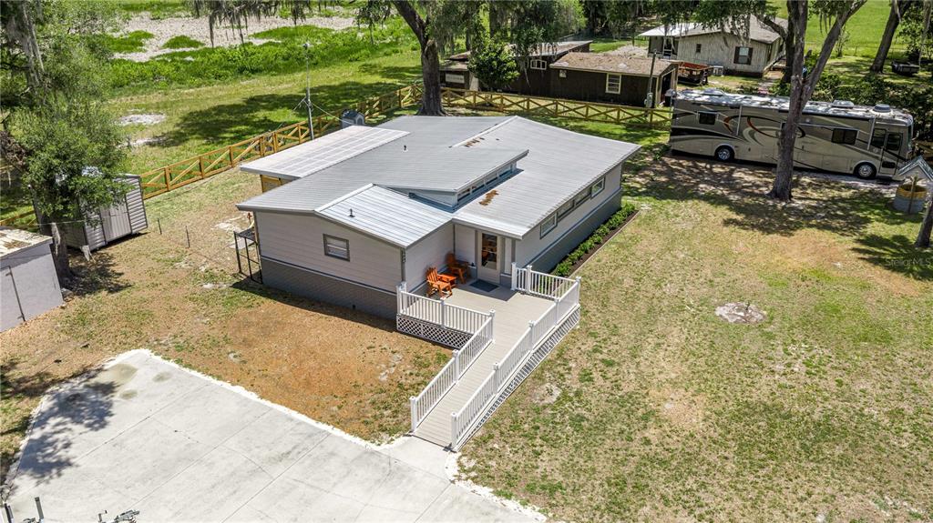 An aerial view shows a single-story house with a metal roof and a wheelchair ramp — 22535 SW 117TH STREET, DUNNELLON, FL
