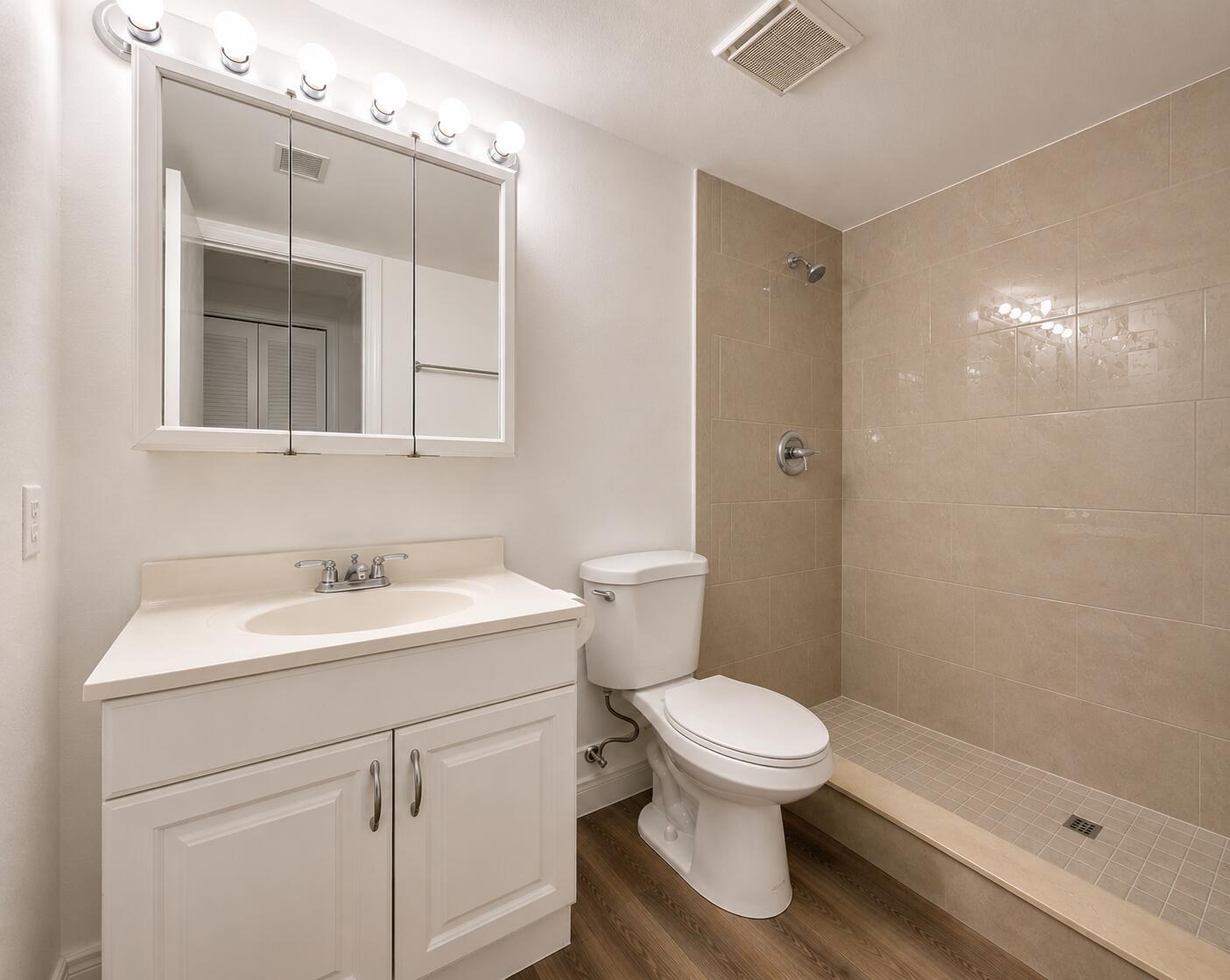 A bathroom featuring a white vanity, a toilet, and a tiled walk-in shower — 601 S State Rd 7 # 2h, Margate FL 33068, MARGATE, FL