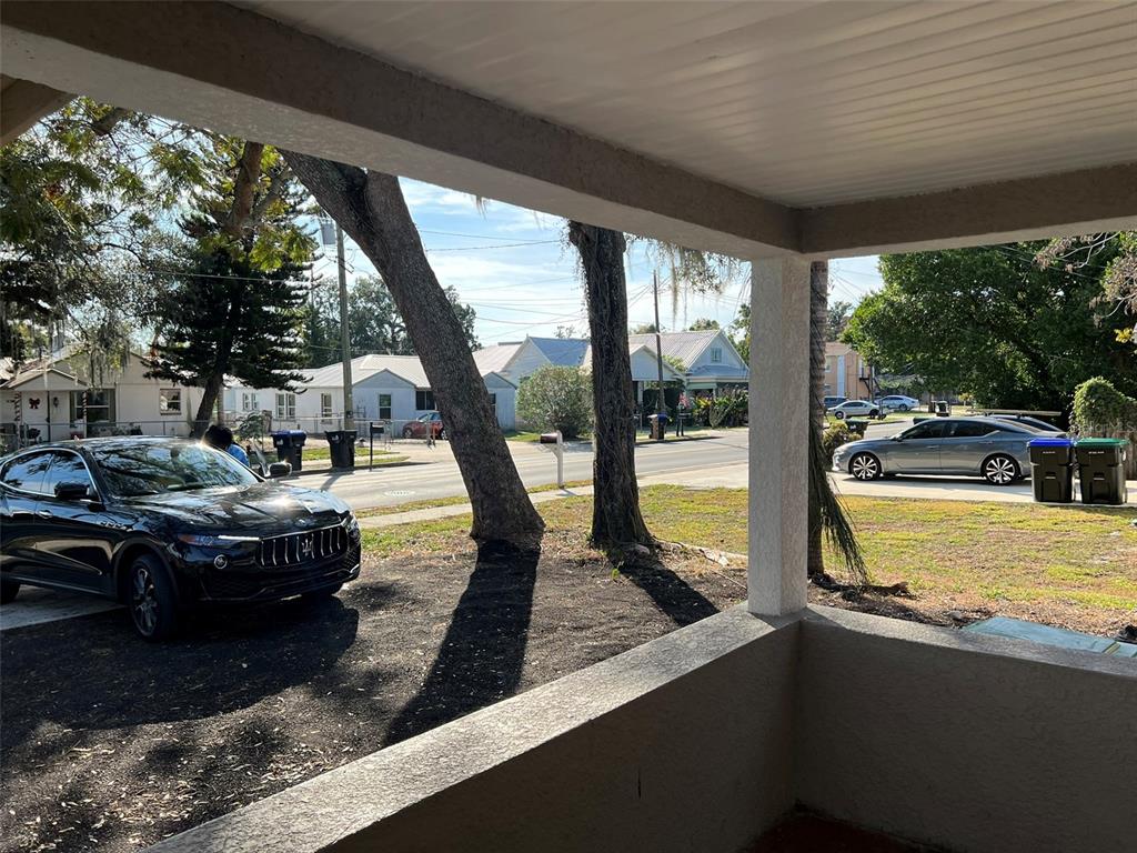 A view from a covered porch looking out at a street with parked cars — 1307 W KALEY AVENUE, ORLANDO, FL