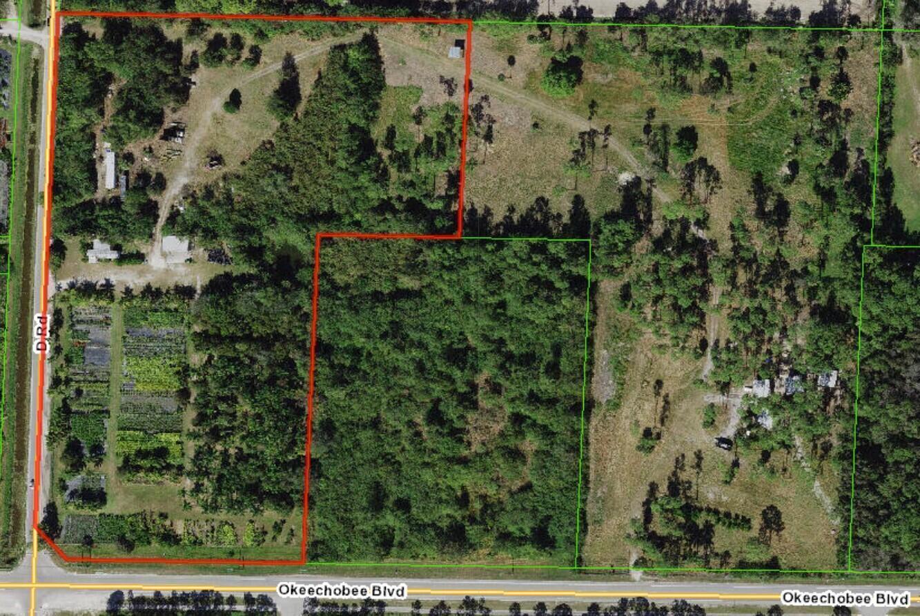 An aerial view shows a plot of land outlined in red along a paved road — 14375 Okeechobee Boulevard, FL 33470, FL