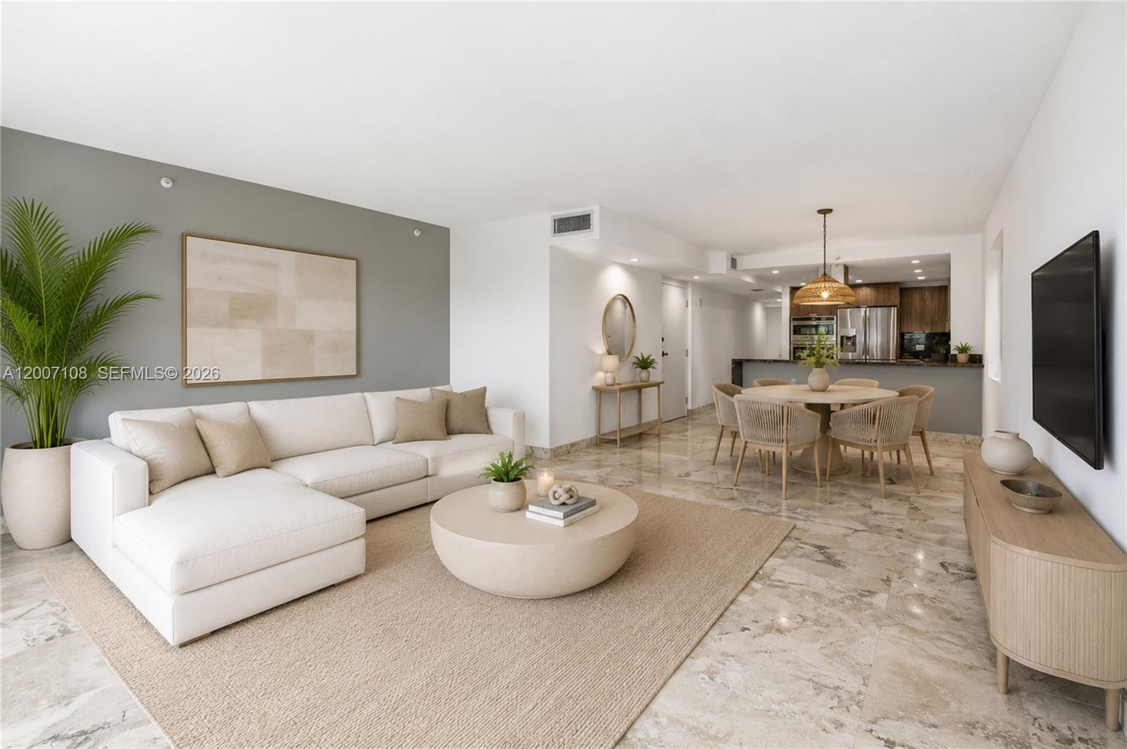 A modern living and dining area features a white sectional, round coffee table, and marble floors — 7824 Collins Ave # 401, Miami Beach FL 33141, MIAMI BEACH, FL