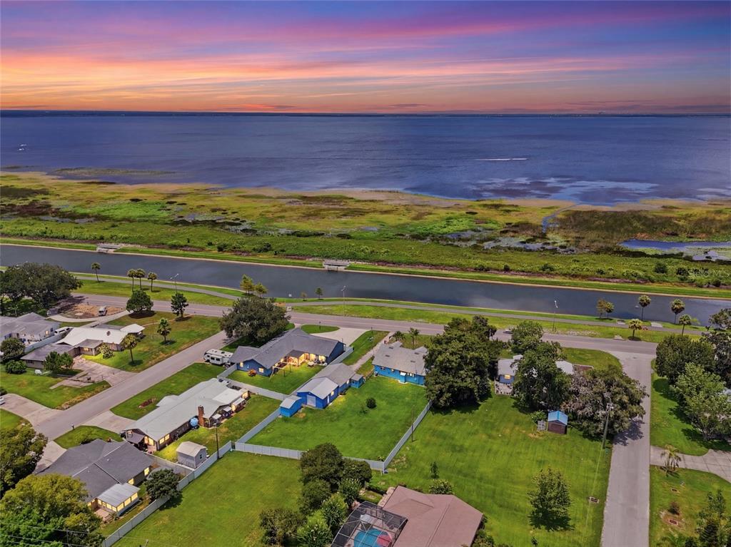 An aerial view of a residential neighborhood situated along a canal and a large lake — 211 LAKESHORE BOULEVARD, ST CLOUD, FL