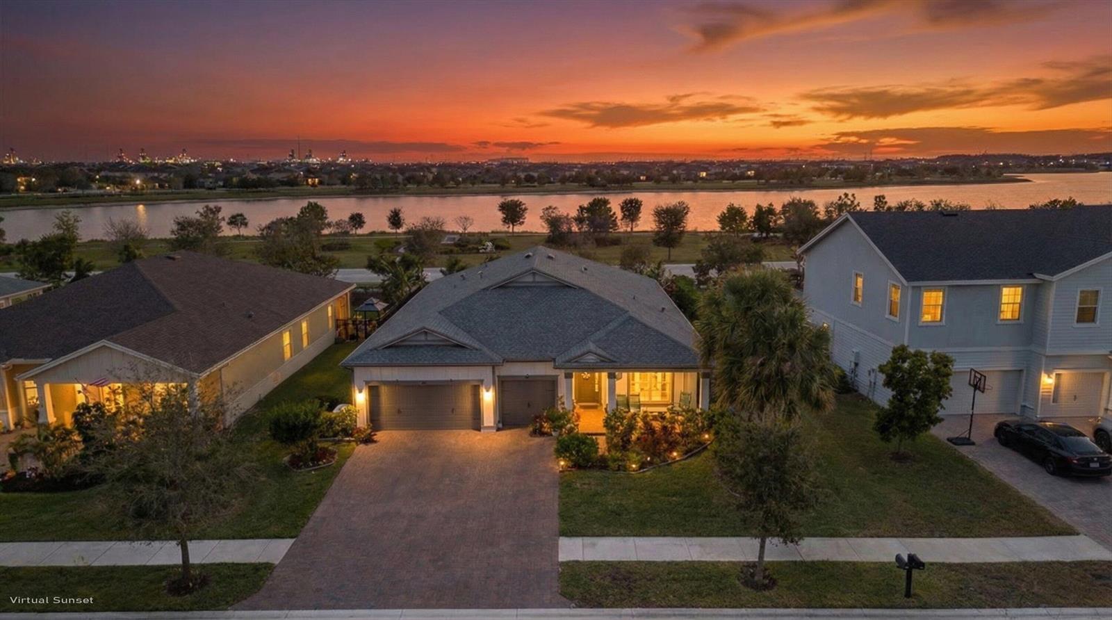 An aerial view of a suburban house at sunset with a lake in the background — 19404 Broad Shore Walk, Loxahatchee FL 33470, LOXAHATCHEE, FL