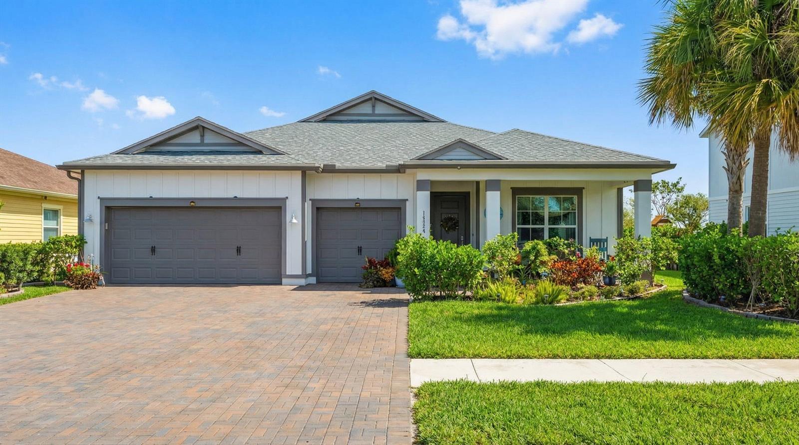 A single-story house with a gray shingle roof, white siding, and a paver driveway — 19404 Broad Shore Walk, Loxahatchee FL 33470, LOXAHATCHEE, FL