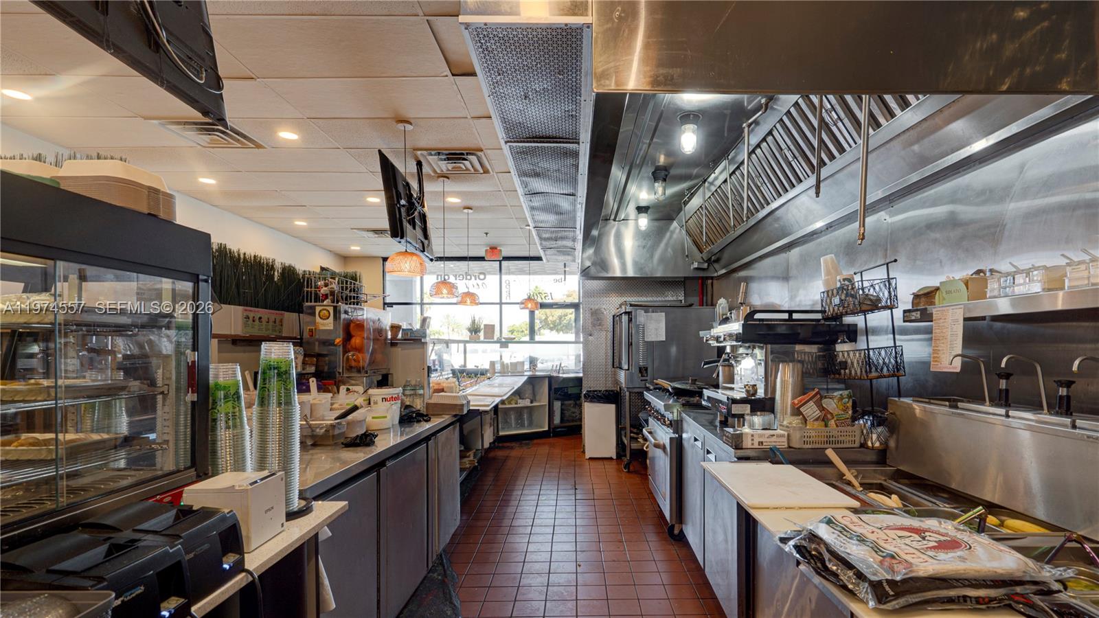 A commercial kitchen features stainless steel equipment, a tiled floor, and a service counter — Kendall Miami, Miami FL 33193, MIAMI, FL