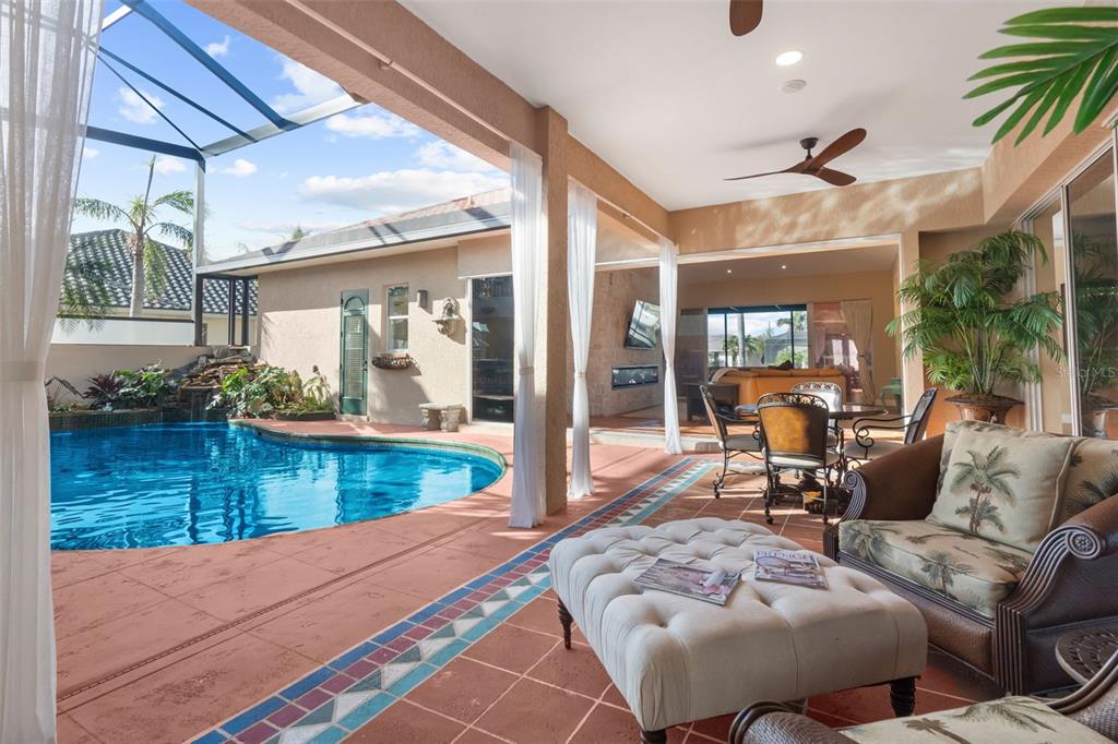 An entryway features a wood-paneled ceiling, double glass doors, and two matching console tables — 3805 SABA COURT, PUNTA GORDA, FL