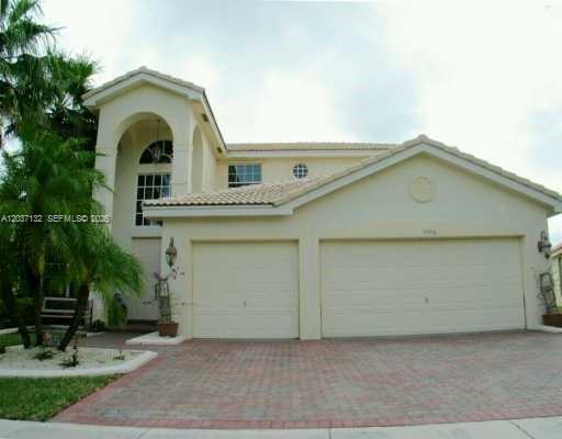A two-story beige house with a two-car garage and a paved driveway — 17958 SW 36th St, Miramar FL 33029, MIRAMAR, FL