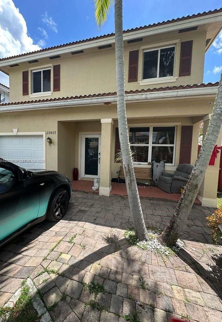 A two-story house exterior features a paved driveway, a front porch, and two palm trees — 28407 SW 129th Pl, Homestead FL 33033, HOMESTEAD, FL