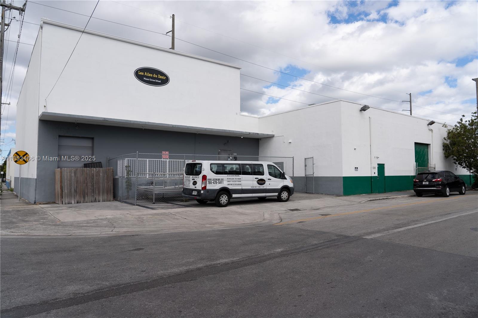 A white industrial building with a van parked in front and a black car nearby — 1395 NW 22nd St, Miami FL 33142, MIAMI, FL