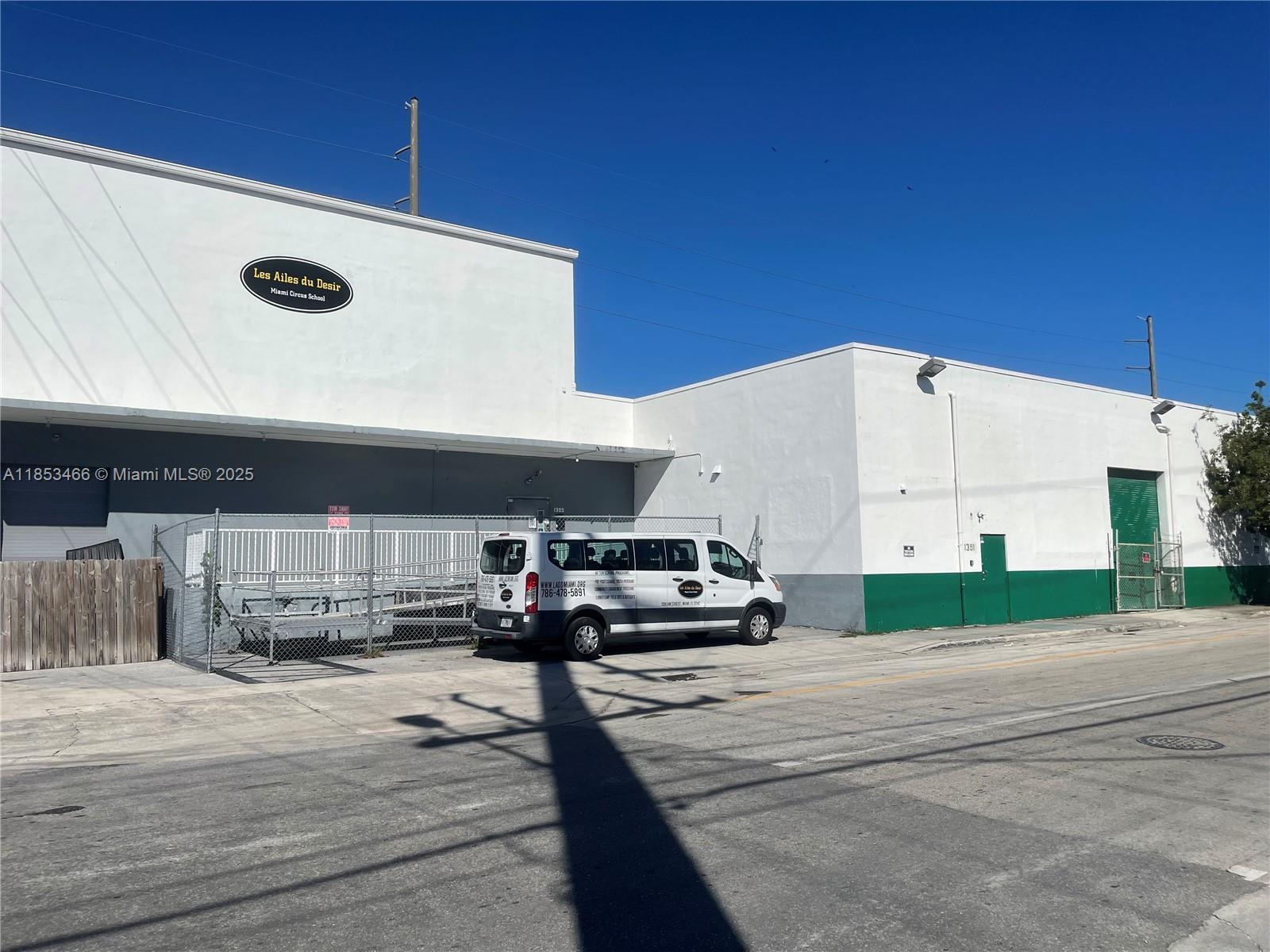 A white commercial building with a green base and a van parked in front — 1395 NW 22nd St, Miami FL 33142, MIAMI, FL