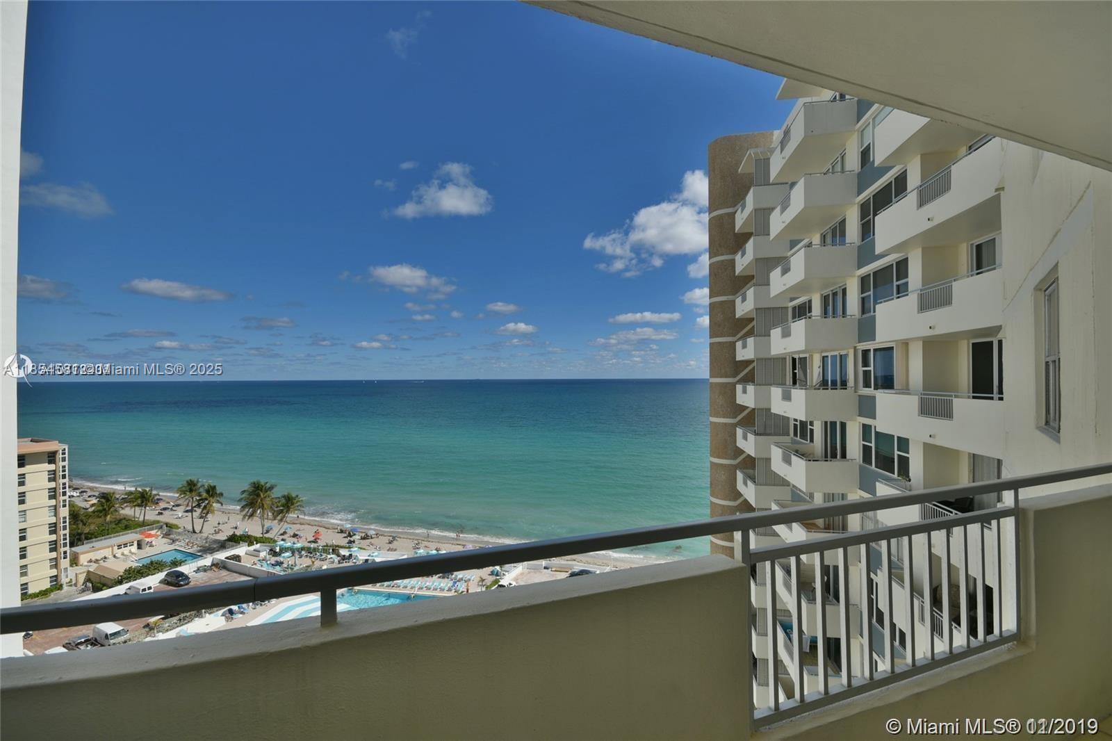 A balcony overlooks a beach, the ocean, and a neighboring high-rise building — 3180 S Ocean Dr # 1204, Hallandale Beach FL 33009, HALLANDALE BEACH, FL