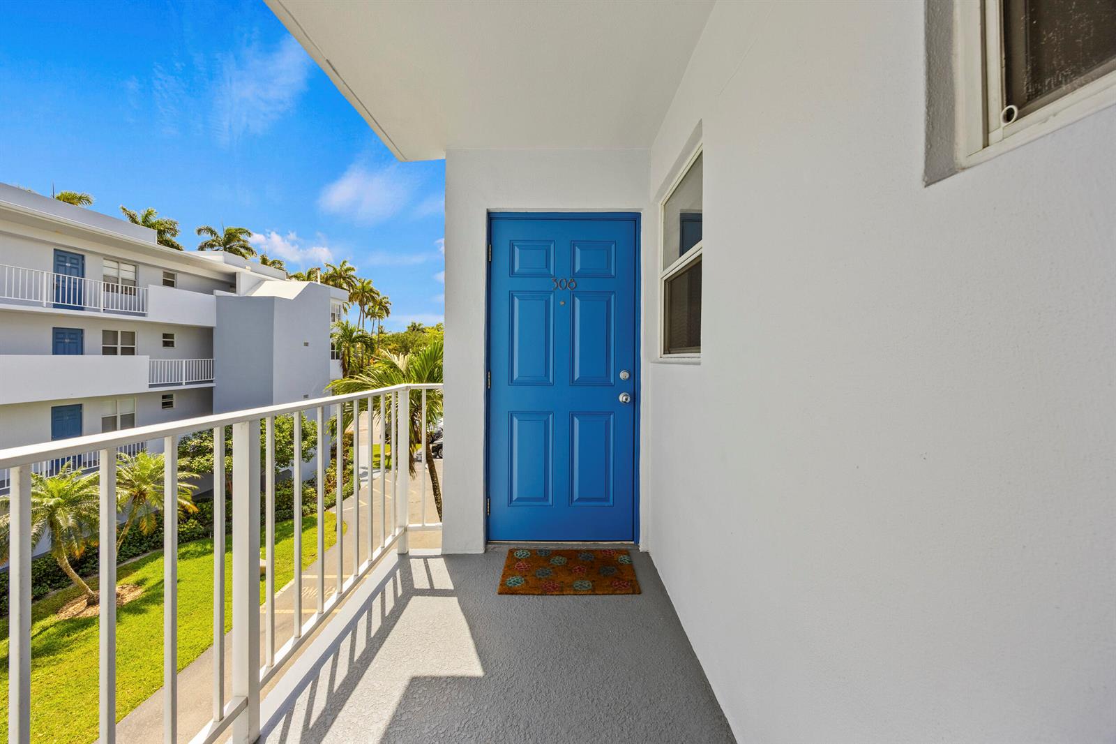 A bright blue front door with the number 308 sits on a gray balcony — 1820 New Palm Way # 308, Boynton Beach FL 33435, BOYNTON BEACH, FL