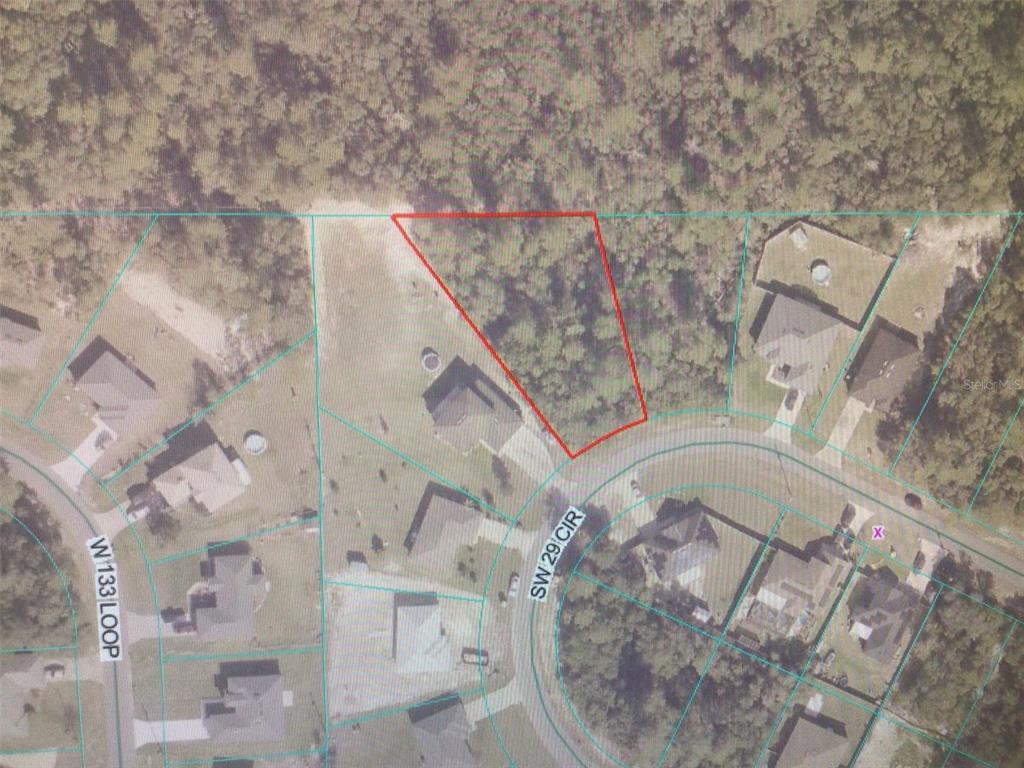 This is an aerial map showing a vacant, wooded residential lot outlined in red — 0 SW 29TH CIRCLE, OCALA, FL
