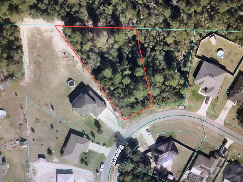 This is an aerial map showing a vacant, wooded residential lot outlined in red — 0 SW 29TH CIRCLE, OCALA, FL