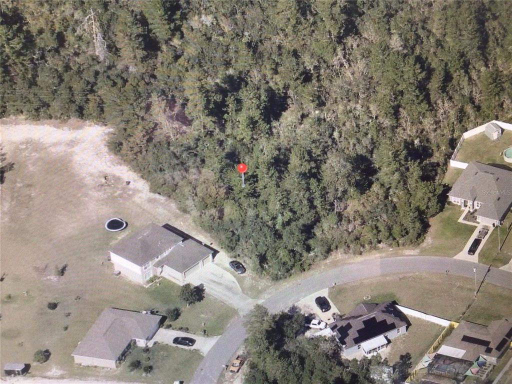 An aerial view shows a wooded residential lot marked with a red pin — 0 SW 29TH CIRCLE, OCALA, FL