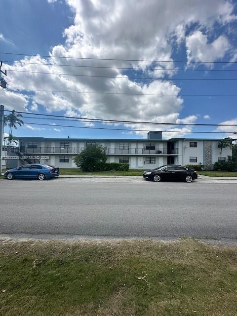 A two-story apartment building with a flat roof stands behind a street and parked cars — 6780 SW 44th St # 2, Miami FL 33155, MIAMI, FL