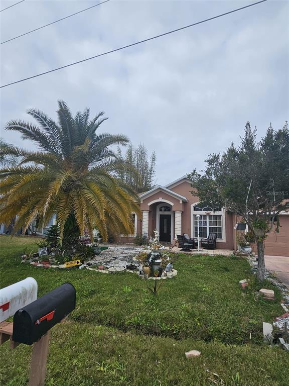 A single-story house with a large palm tree, a front porch, and two mailboxes — 807 MASSY COURT, KISSIMMEE, FL