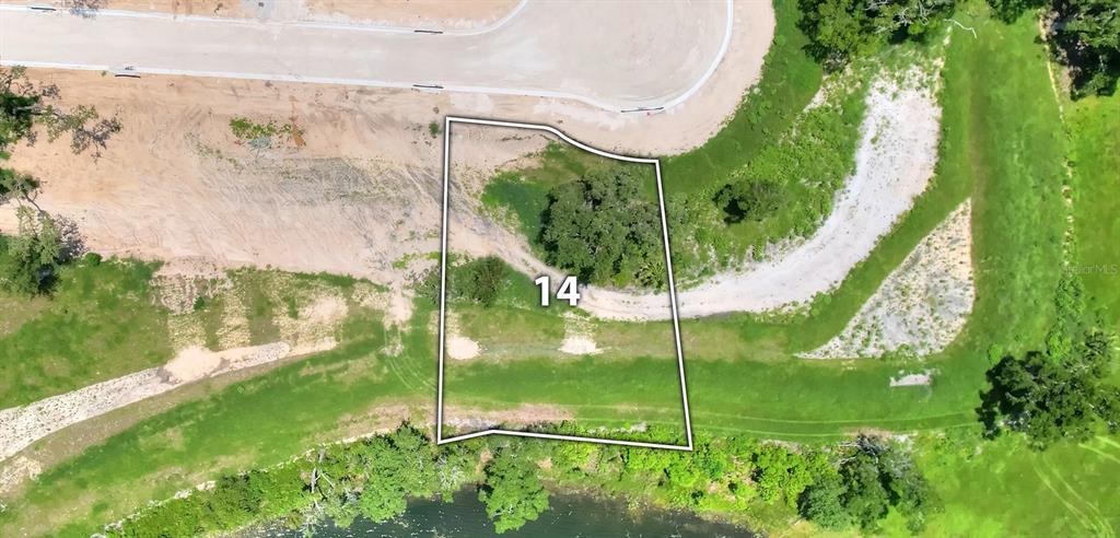 This is an aerial view of a vacant residential lot marked with the number 14 — 141 TRANQUIL MIRROR LAKE COURT Lot 14, CLERMONT, FL