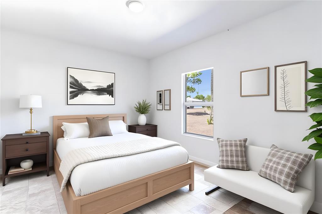 A bedroom features a wooden bed, a white sofa, and a window with exterior views — 1413 BITTERSWEET STREET, LAKE PLACID, FL