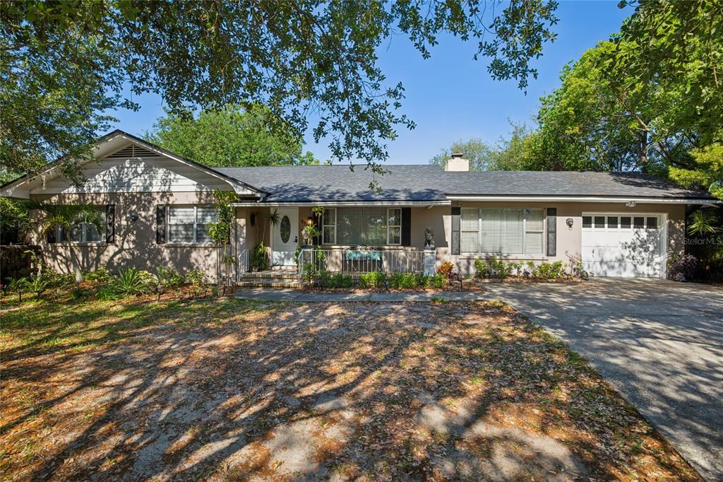 A single-story house with a gray roof, tan siding, and an attached garage — 804 WOODRUFF AVENUE, CLEARWATER, FL