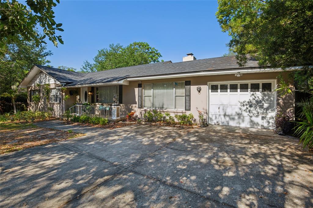 A single-story house with a concrete driveway, a white garage door, and a front porch — 804 WOODRUFF AVENUE, CLEARWATER, FL