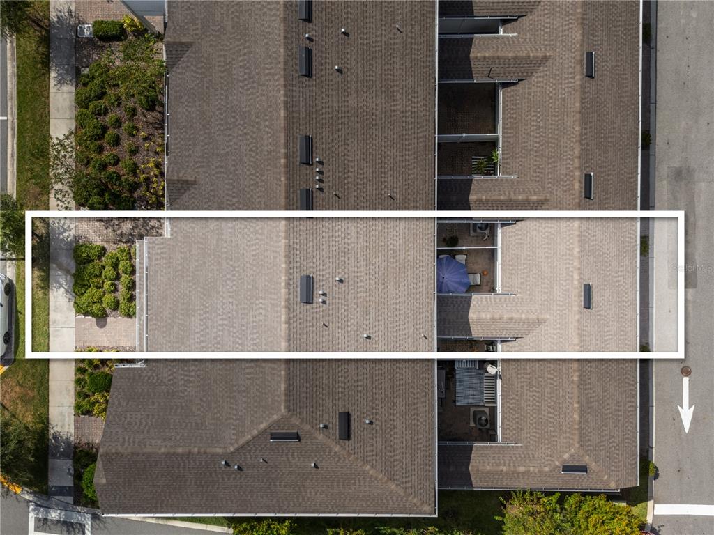 An aerial view shows the roof and patio of a townhome unit within a complex — 14514 ORCHID ISLAND DRIVE, ORLANDO, FL