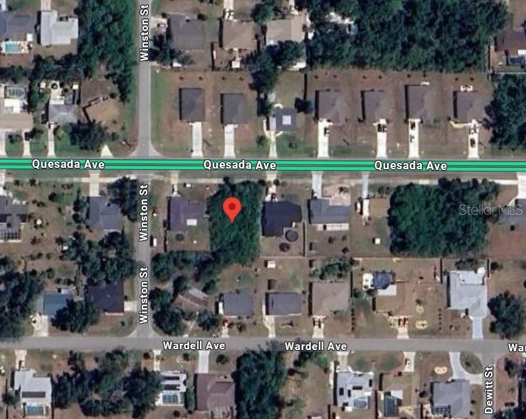 This is an aerial map view of a vacant residential lot located between two houses — 21271 QUESADA AVENUE, PORT CHARLOTTE, FL