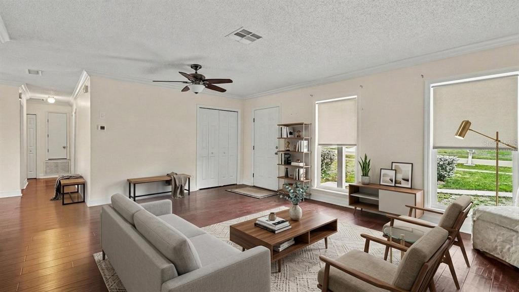 A living room with wood floors, a ceiling fan, and two windows with roller shades — 2434 W GARDENIA DRIVE, CITRUS SPRINGS, FL