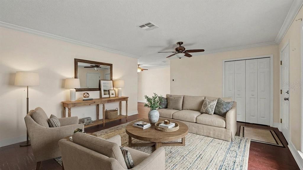 A living room features a beige sofa, two armchairs, a round coffee table, and console table — 2434 W GARDENIA DRIVE, CITRUS SPRINGS, FL