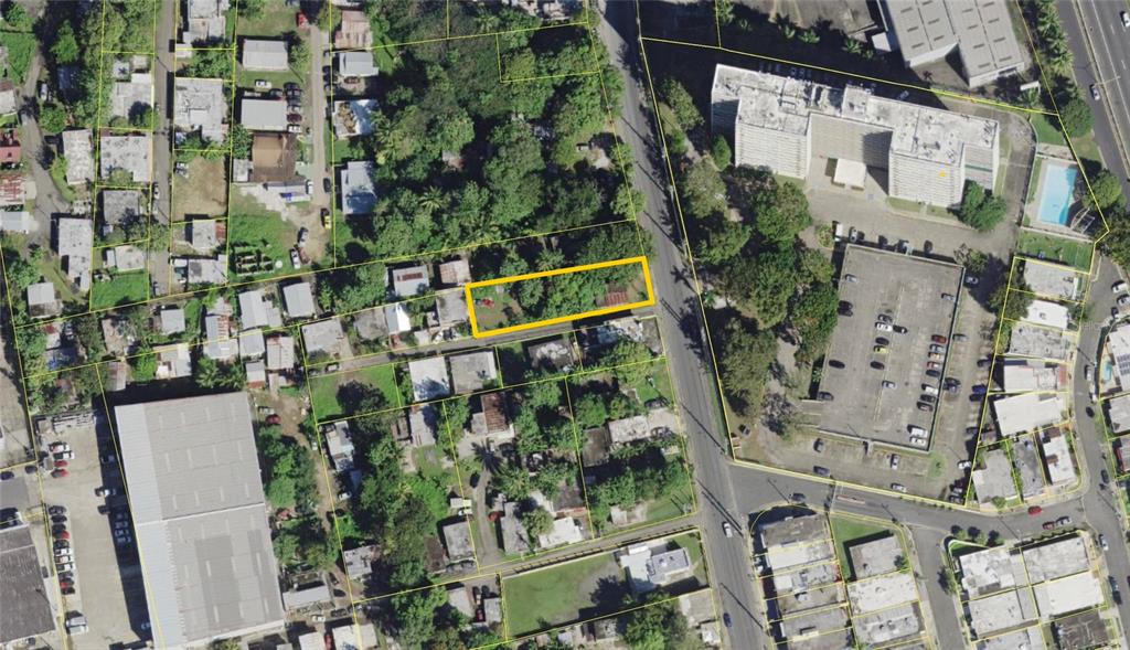 An aerial view shows a rectangular lot outlined in yellow within a residential neighborhood — CALLE ANDINO, CAROLINA, PR