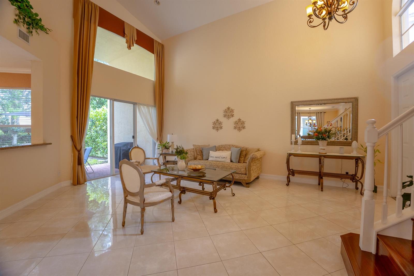 A living room with high ceilings, tile floors, a glass coffee table, and a sofa — 8789 Sandy Crest Lane, Boynton Beach FL 33473, BOYNTON BEACH, FL