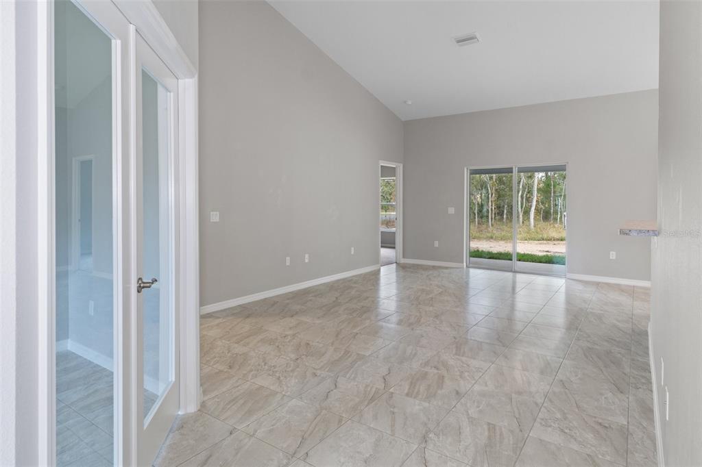 A kitchen features light wood cabinets, granite countertops, stainless steel appliances, and a breakfast bar — 17 HAWTHORNE COURT, HOMOSASSA, FL