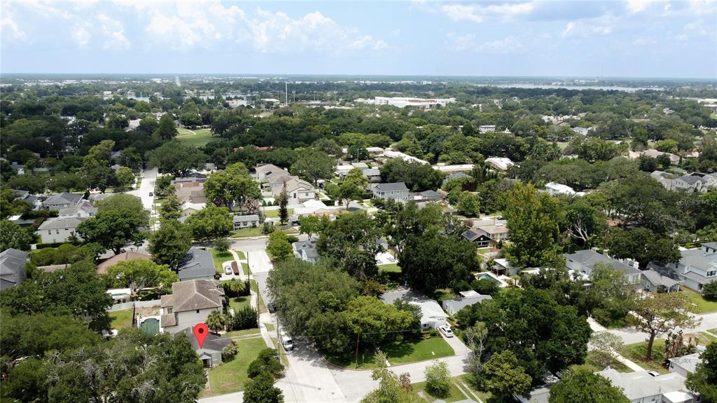 An aerial view shows a residential neighborhood with a red location pin marking a house — 2942 HELEN AVENUE, ORLANDO, FL