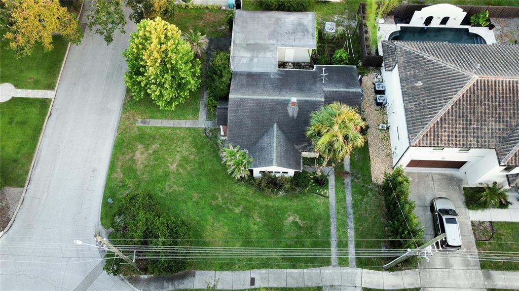 An aerial view shows a house with a dark roof, a yard, and a driveway — 2942 HELEN AVENUE, ORLANDO, FL