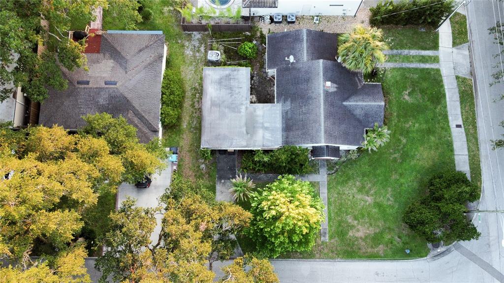 An aerial view shows two houses with shingled roofs, surrounding trees, and a grassy lawn — 2942 HELEN AVENUE, ORLANDO, FL