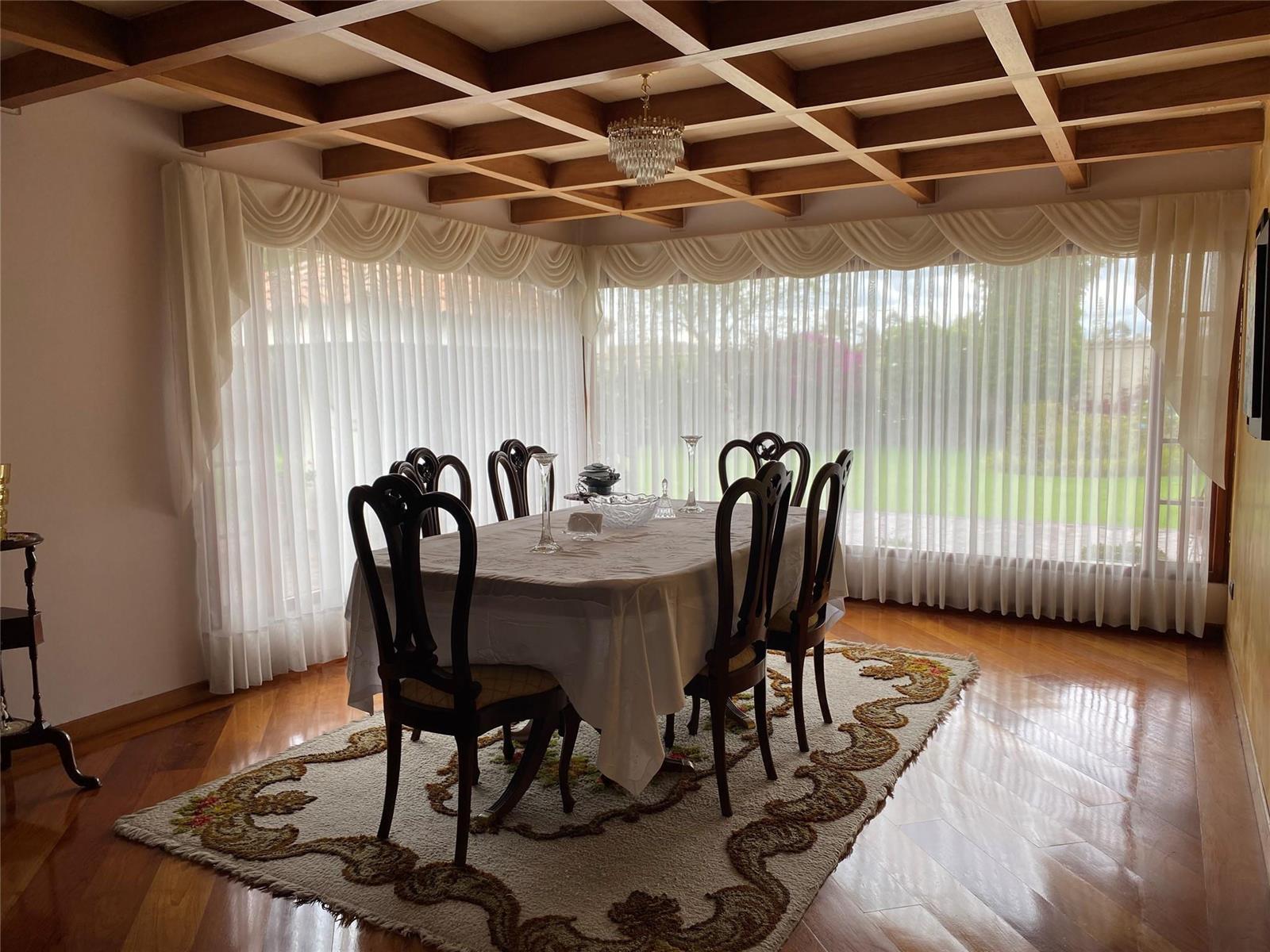 A dining room features a coffered wood ceiling, a patterned area rug, and floor-to-ceiling curtains — NOT IN USA Not In Usa Guaymaral- Colombia, FL
