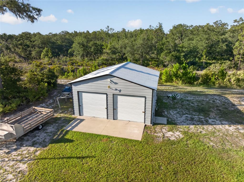 An aerial view of a detached two-car metal garage with a white roof and siding — 4101 POINCIANA DRIVE, INDIAN LAKE ESTATES, FL